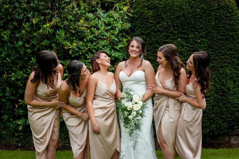 Five bridesmaids wearing matching smokey eye makeup for evening wedding