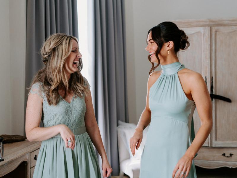 bridesmaid with different makeup looks laughing