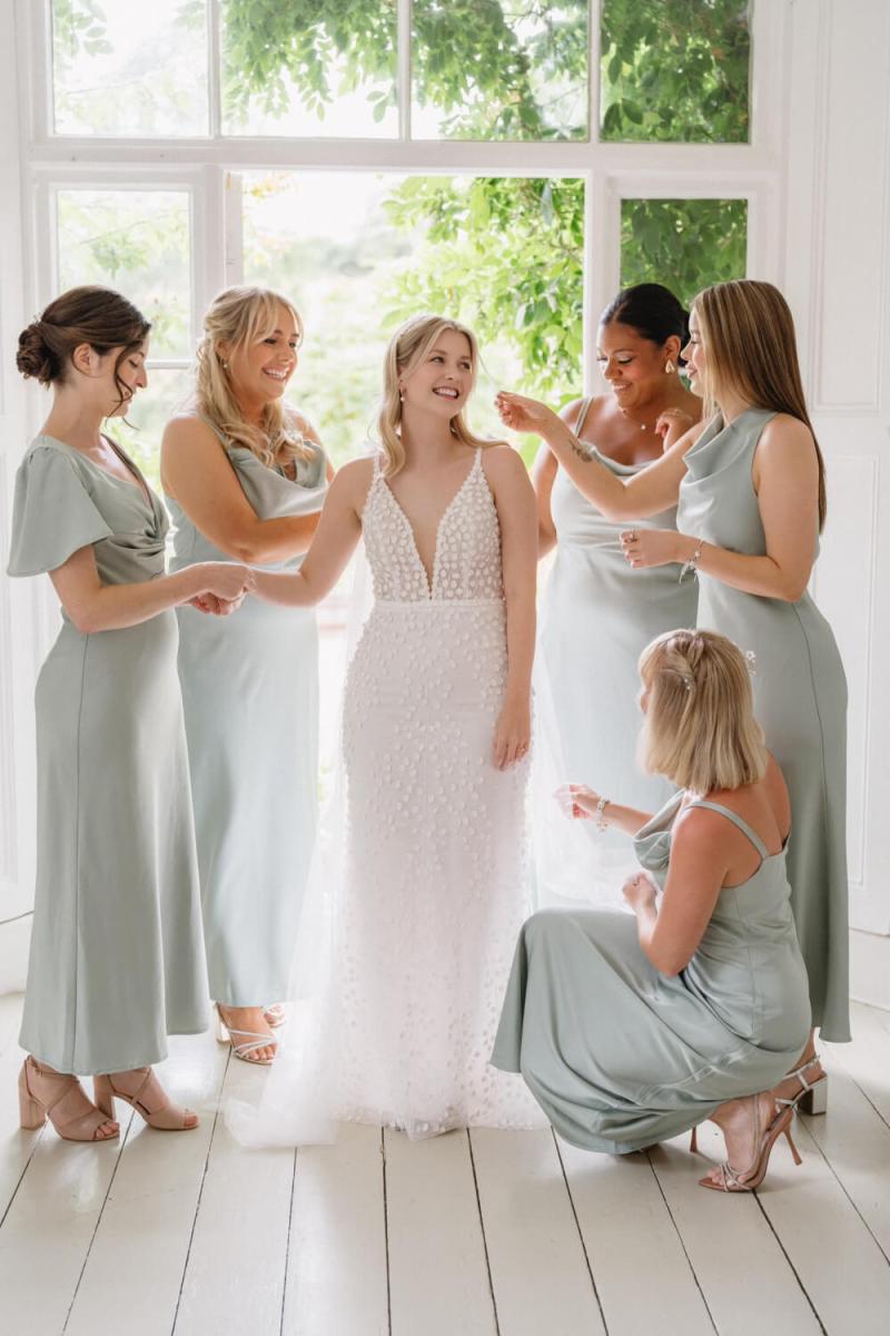 Bridesmaids posing together with matching dewy makeup looks