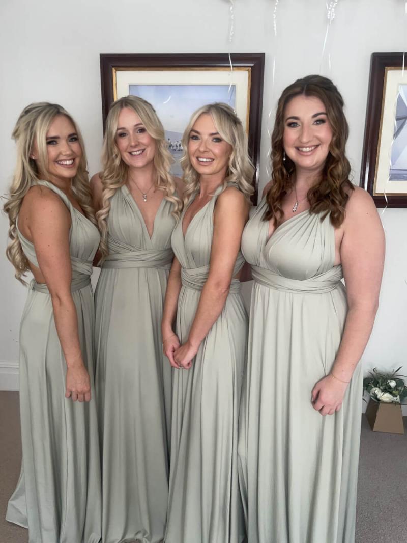 Bridesmaids posing together with matching dewy makeup looks