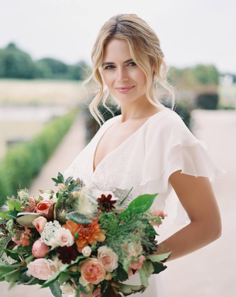 amazing-face-bridal-hair-make-up-dorset-wedding-portfolio-1621226272.jpeg Close up of bridal eye makeup in warm gold tones on a blonde bride