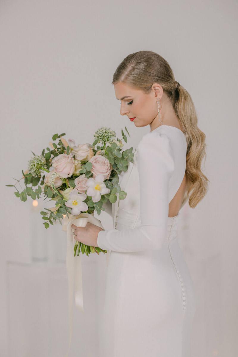 big-hair-energy-by-tiel-wedding-portfolio-1689288217.jpeg bride with long pony tail and long sleeves