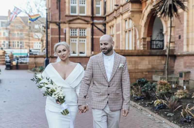 tetiana-kurtyniuk-wedding-portfolio-1696357655.jpeg bride with hair up wearing long-sleeved dress with groom