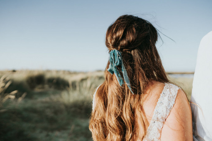 A beautiful ribbon styled into a half up half down look. Perfect for a Boho bride - Make Me Bridal Artist: Glow-Occasion Hair Specialists. Photography by: Beth beresford photography. #bohemian #boho #halfuphair #curls #bridalhair #bowinhair