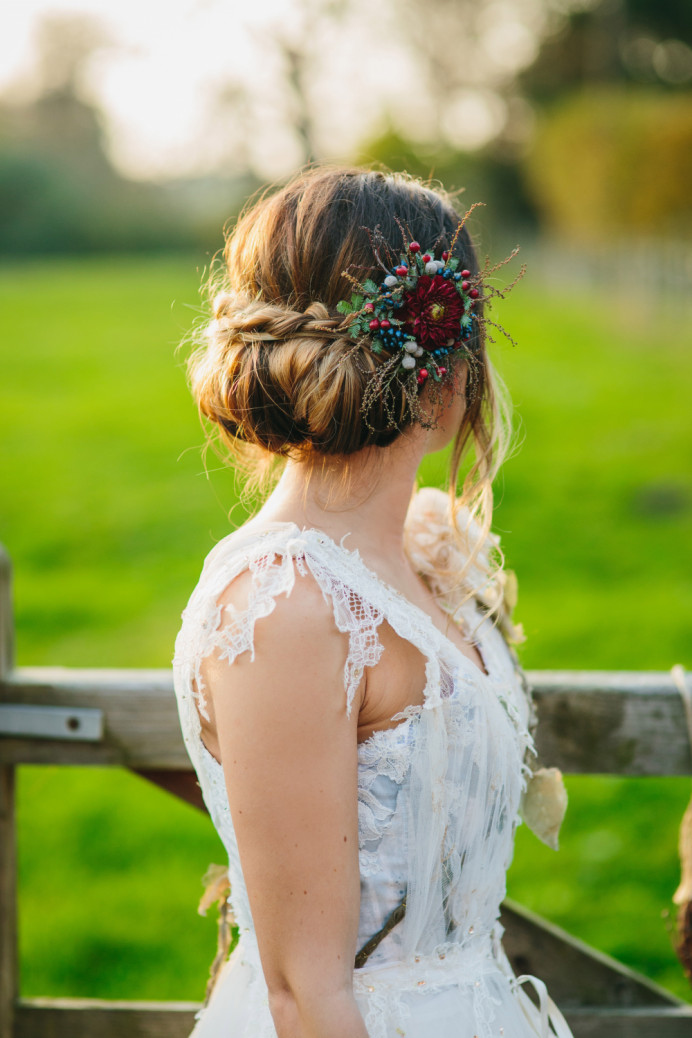 Rolled undo with braid and floral accessory - Make Me Bridal Artist: The studio effect . Photography by: Richard wakefield. #bridalhair #flowersinherhair #rustic #lowupdo #relaxedupdo #braidedupdo #flowers #bohobride #undoneupdo #countrywedding #floralaccessory #outdoorwedding