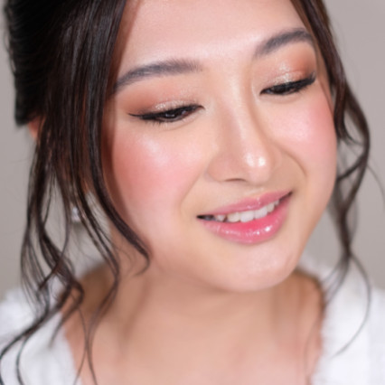 Beautiful House of Howes Bride, Bonnie Woo. Bonnie requested a soft updo with a fresh, dewy complexion and eye makeup to subtly open up her eyes.The secret to that effortless glow? Proper skin prep! When done right, it gives you that radiant, skin-like finish every bride dreams of. - Photography by: Lourdgene Howes. #dewyskin #freshmakeup #healthyglow #naturalmakeup #bridalmakeup