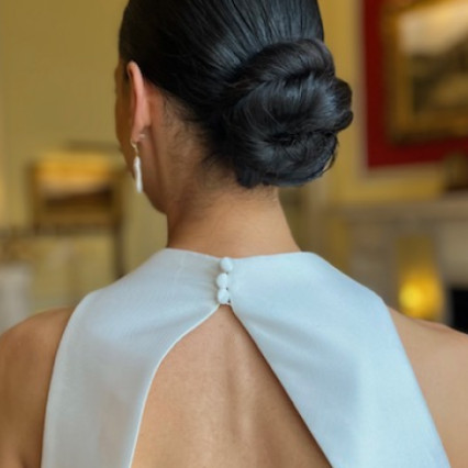 This classic bun was smooth, minimal and worked perfectly with the high neckline of my brides wonderful dress. - Photography by: Andrea Godfrey Photgraphy. #lowbun #londonbride #smoothbun #clean