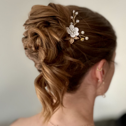 This was a bridesmaids hair that wanted a Morden updo with loose pieces. - #updo #highbun #messyupdo