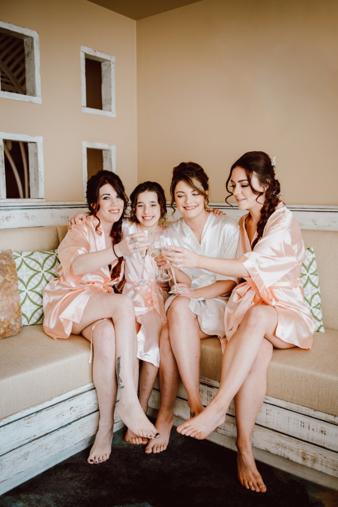 Bride Sam and all her bridesmaids and flower girl had hair and Make Up and I love this moment that is captured of them all together and having a toast! What a great start to the day! - Make Me Bridal Artist: Jenna West Make Up. Photography by: Jessica Bevan. #weddingmorning #bridesmaidhair #bridesmaidhairandmakeup #bride #bridsmaidmakeup