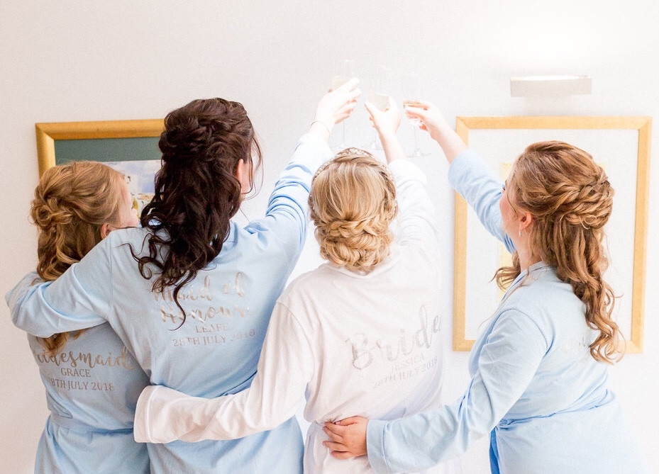 Bridal party - raising a glass and showing their lovely hair. - Make Me Bridal Artist: Amanda Roberts Hair & Makeup. Photography by: Philippa Sian. #halfuphair #weddingmorning #bridalhair #bridesmaidhair #weddinghair #hairup #bridalparty